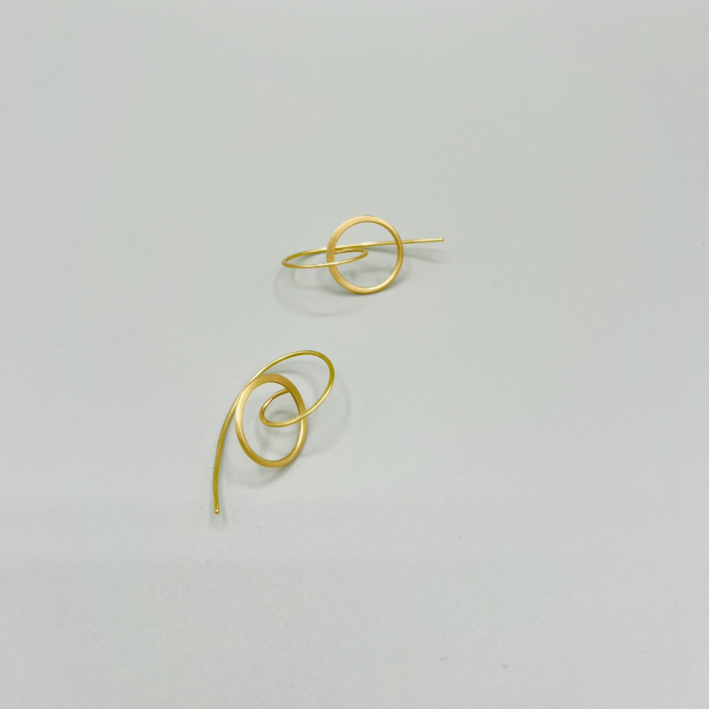 Handgeschmiedete Creolen aus Gelbgold -haben eine Leichtigkeit durch filigrane Form und kreisförmige Struktur.